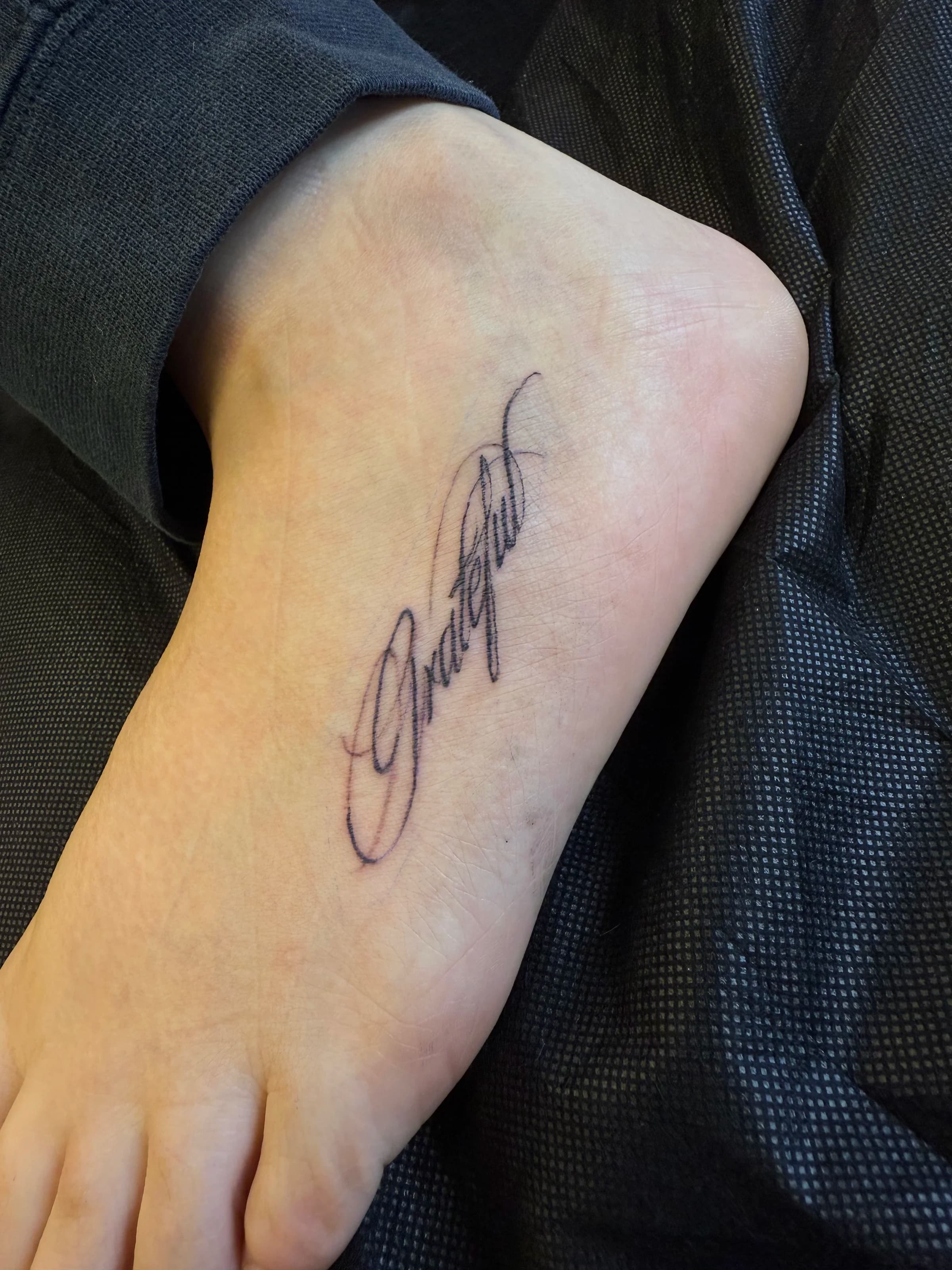 Cursive grateful script on foot, black and white