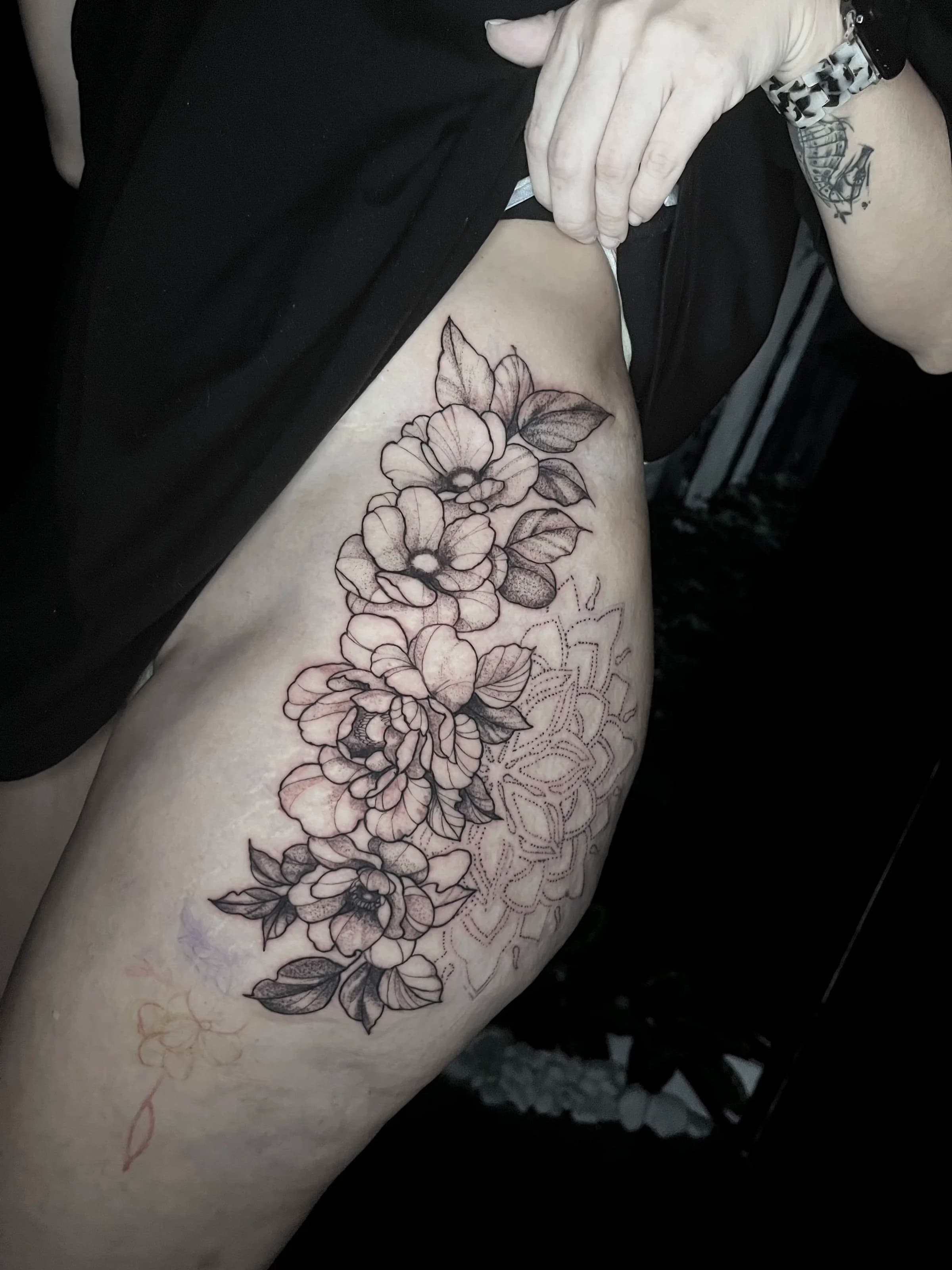 Floral fine line thigh tattoo
