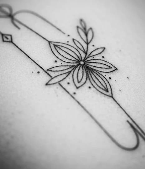 Floral bloom on a safety pin with dotwork accents
