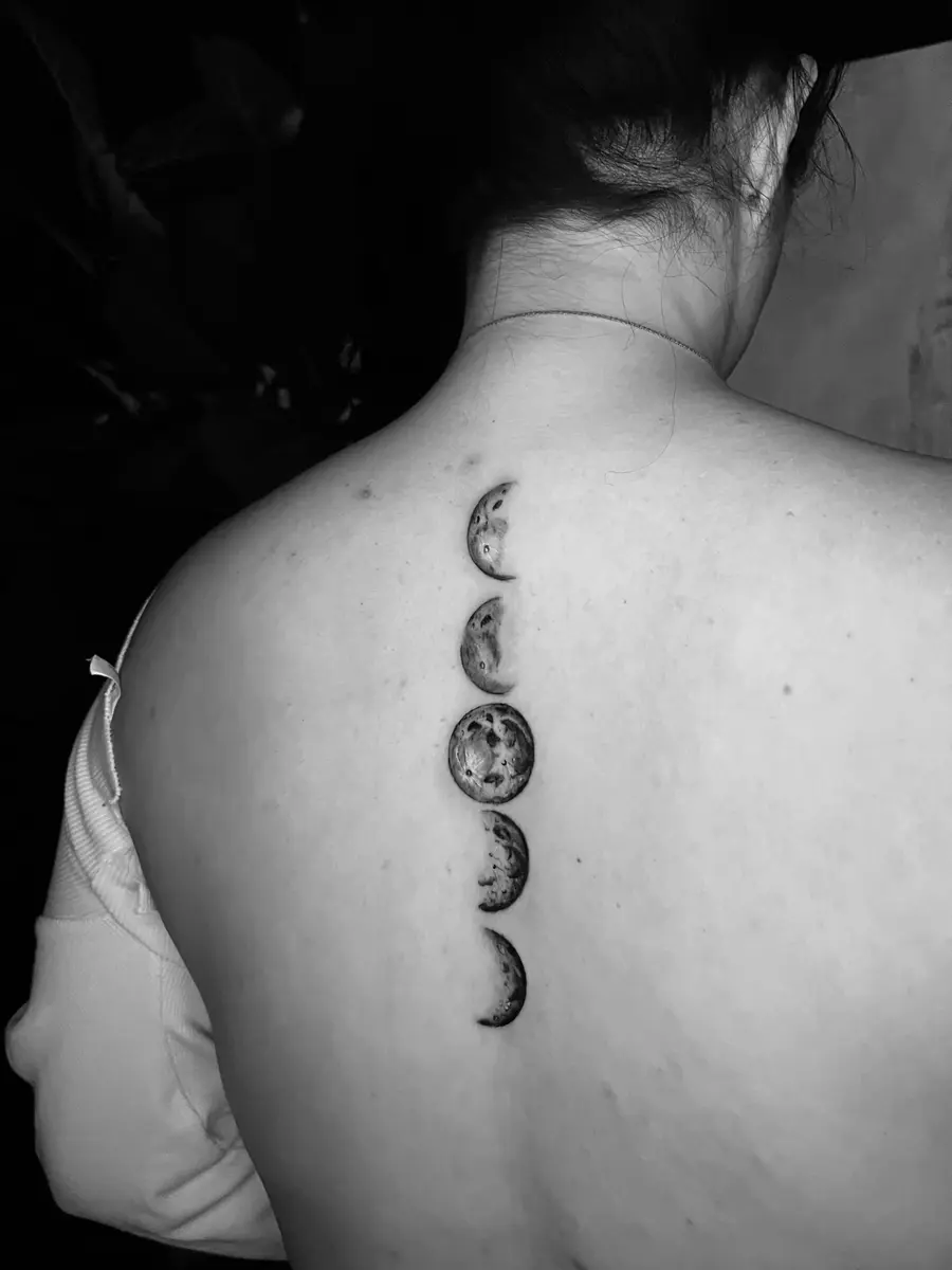 Geometric tattoo by Eunny — precise symmetry and repeating linear pattern